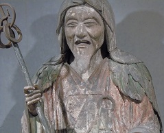 ancient wooden sculpture, life-size old man